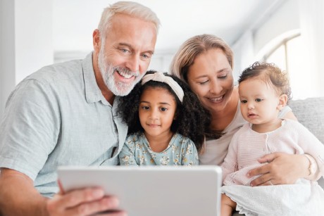 Family smiling at laptop